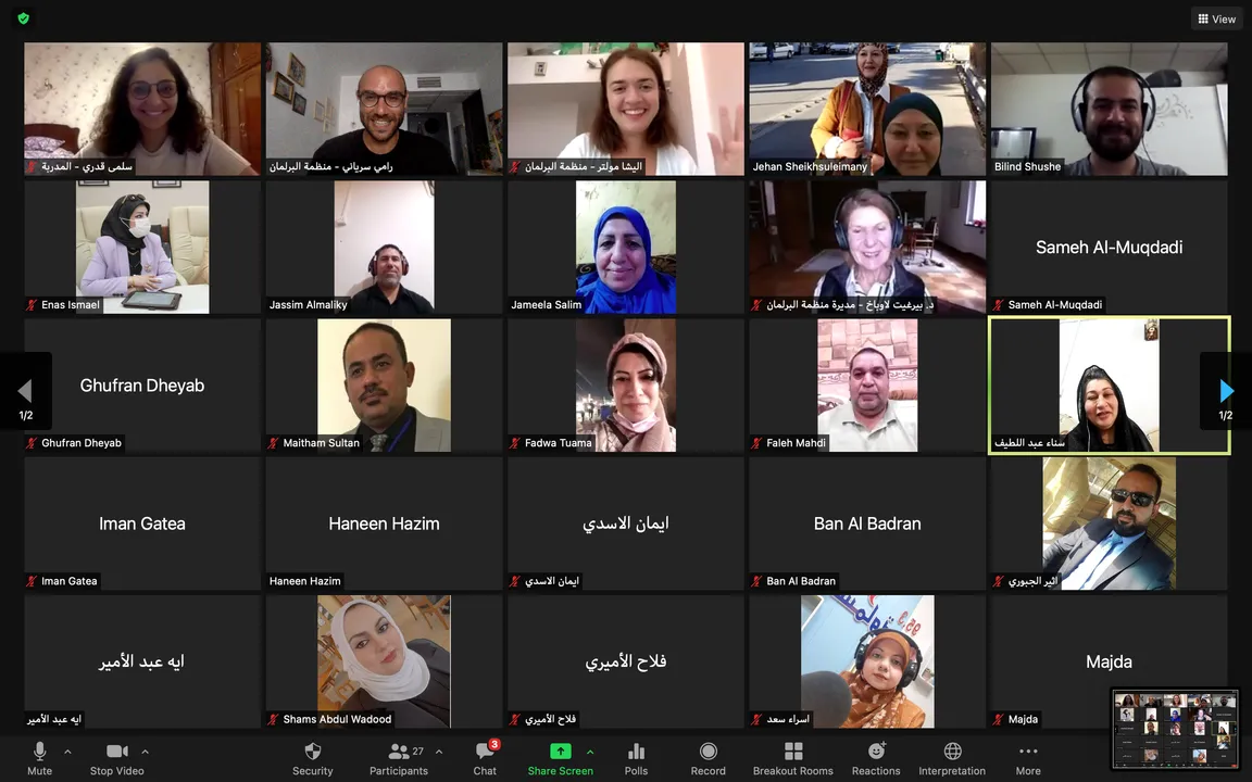 Video conferencing grid showing numerous participants in individual tiles, with on-screen meeting controls at the bottom.