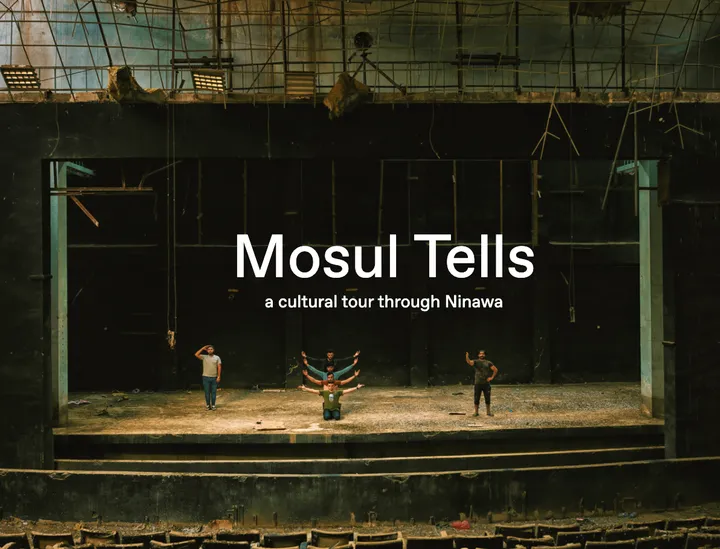 Derelict theatre stage with exposed rigging and rubble, four people standing and kneeling on it, overlaid with the text "Mosul Tells" and "a cultural tour through Ninawa", empty seats in the foreground.