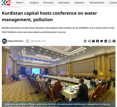 News article screenshot headlined "Kurdistan capital hosts conference on water management, pollution", with a photo of people seated around a long conference table.
