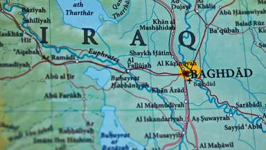 Close-up of a physical map showing Iraq, including Baghdad, Fallujah and the Euphrates river, with place names in English transliteration.