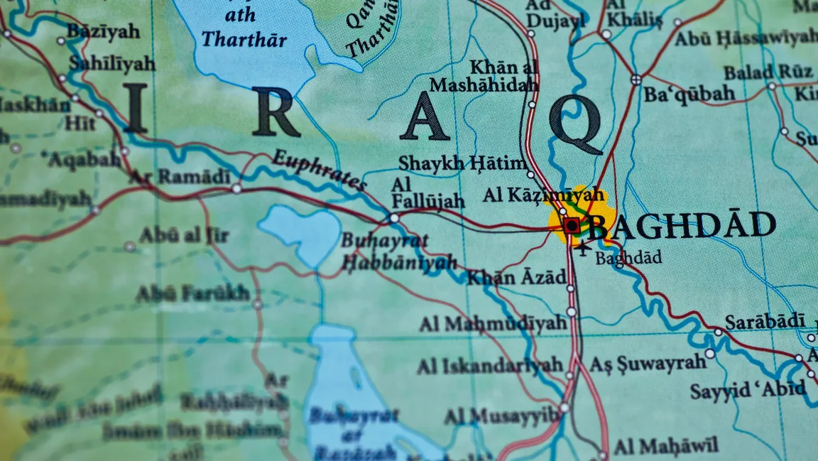 Close-up of a physical map showing Iraq, including Baghdad, Fallujah and the Euphrates river, with place names in English transliteration.